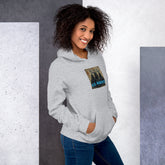 Light gray unisex hoodie with front hood, pouch pocket, and chest logo graphic